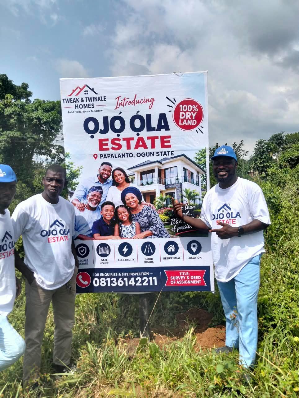 Team members at the Ojo-Ola Estate signboard in Papalanto